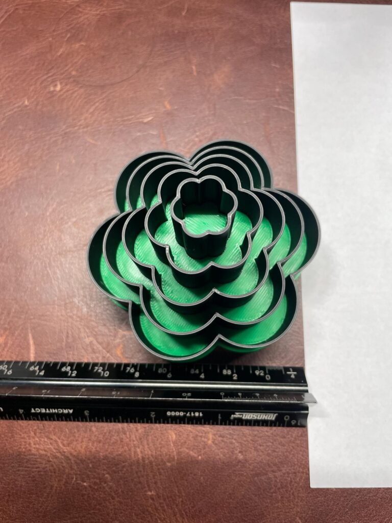 Graduated cookie cutter set, flower shape with ruler for sizing.