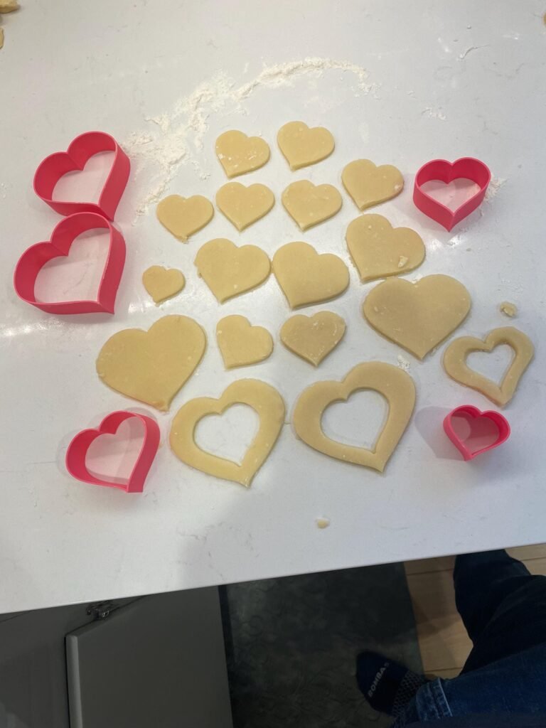 Cookie cutouts and graduated heart shaped cookie cutter set in pink.