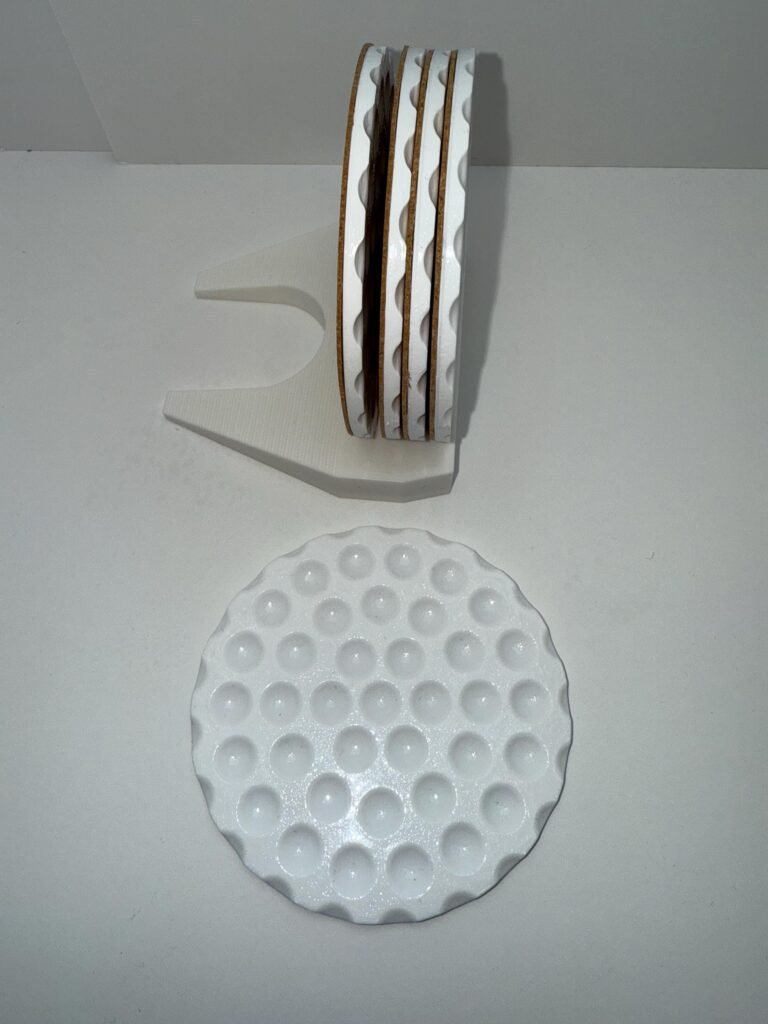 Golf ball drink coasters, resin, with putter 3D printed holder.
