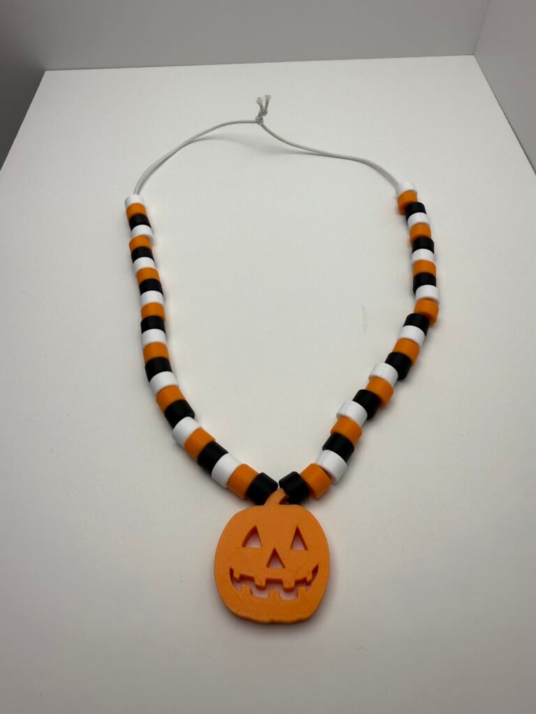 Jack O' Lantern fall or halloween necklace.  Elastic string and orange, black and yellow pony style beads.