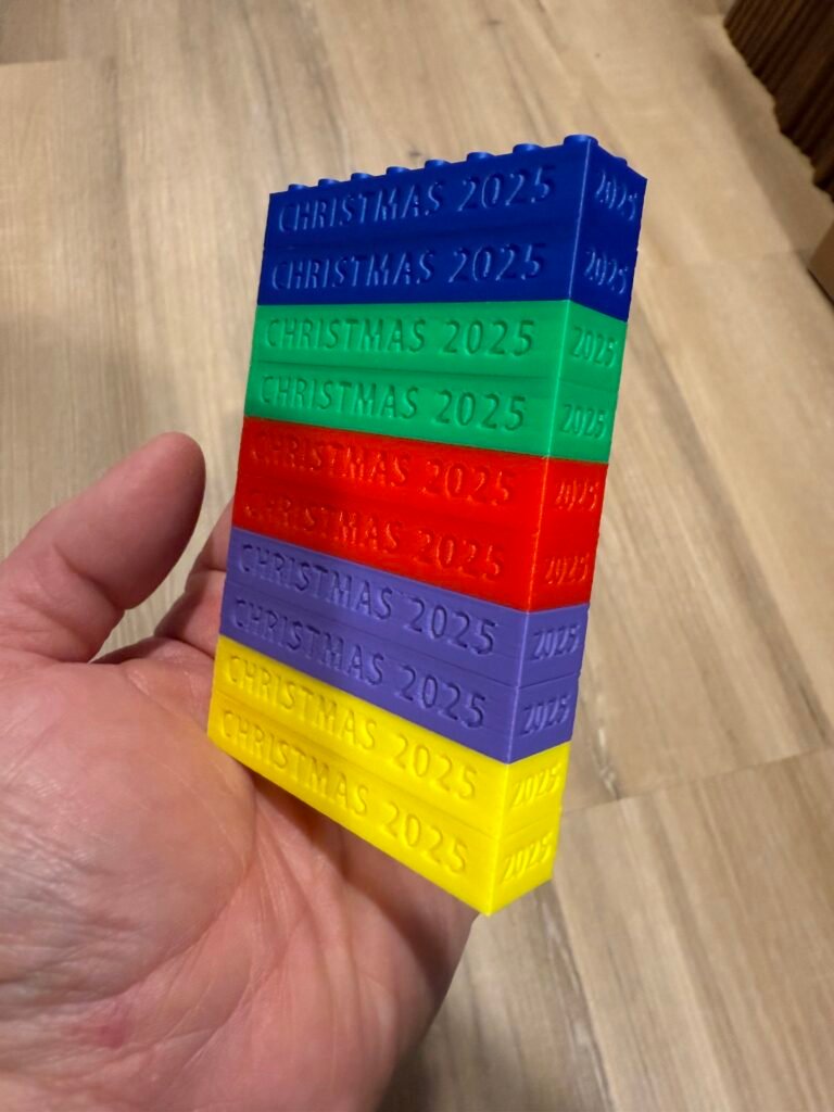 Blue, green, red and purple building block party favor with personalized message.