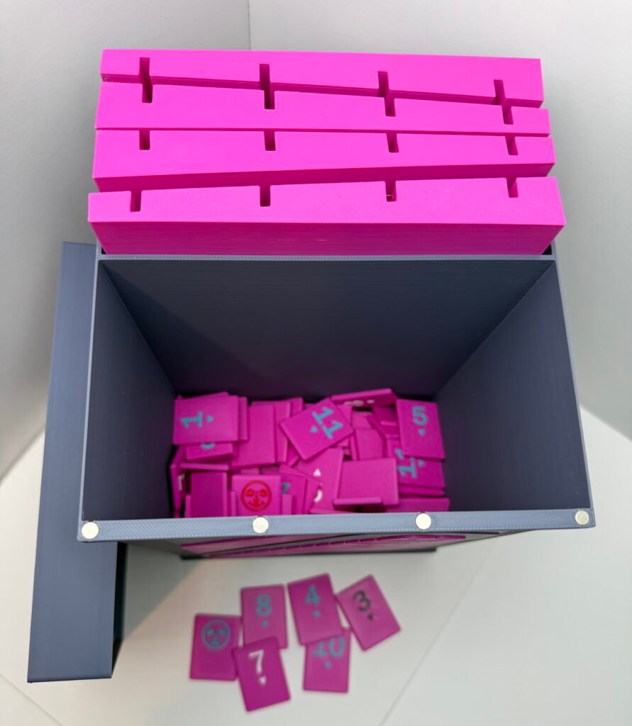 Custom Magenta and Blue Gray Rummikub set featuring a box with a magnetic lid, storage for four piece holders and area for Rummikub cards.