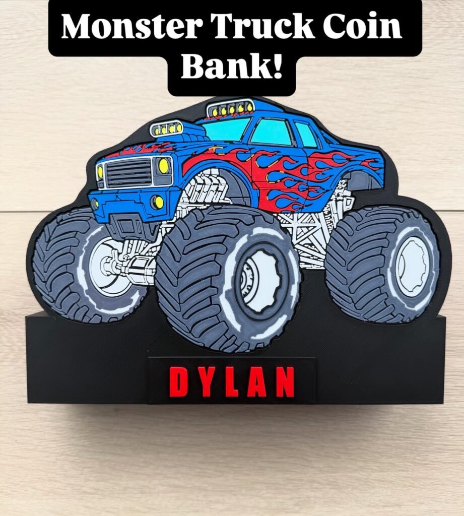Personalized monster truck piggy bank with blue body and orange/red flames on chassis.  Detailed with wheel ridges and undercarriage/engine parts.