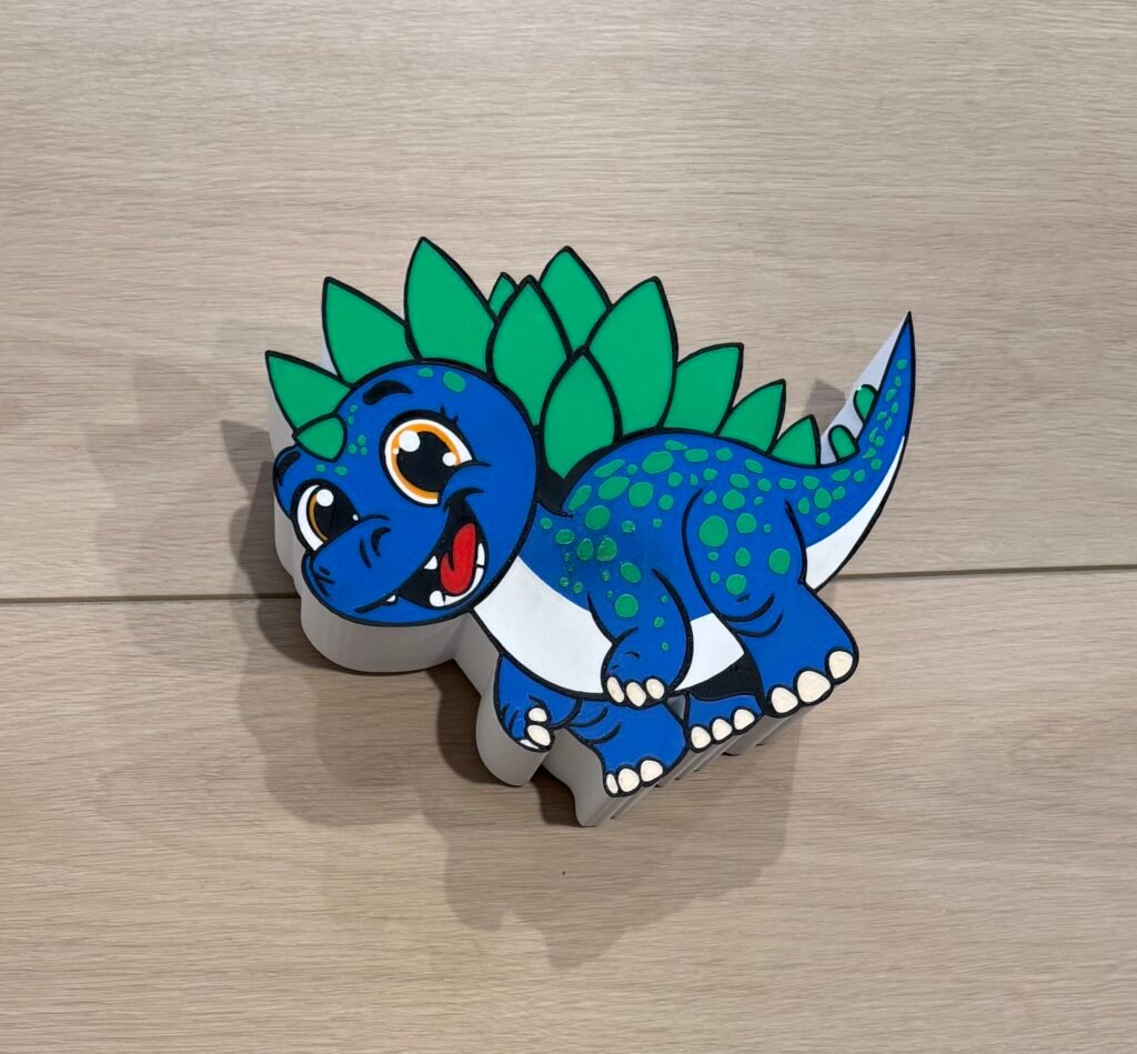 Stegosaurus Piggy Bank, Blue, Green, White with Orange eyes.